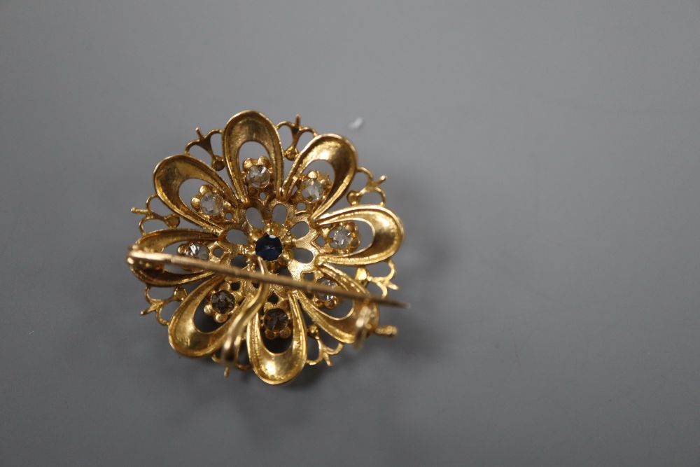 A French yellow metal (poincon mark for 18ct), sapphire and diamond set flower head pendant brooch,